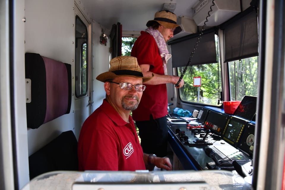Strojvedoucí Alexandr Šmíro mladší (vzadu) zacvičuje nového kolegu Rostislava v obsluze motorových lokomotiv. | Foto: Břetislav Tureček, Radio Prague International Strojvedoucí Alexandr Šmíro mladší (vzadu) zacvičuje nového kolegu Rostislava v obsluze motorových lokomotiv. | Foto: Břetislav Tureček, Radio Prague International